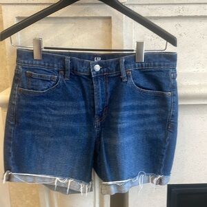Gap Indigo blue distressed jean shorts. Size 29. Never worn .